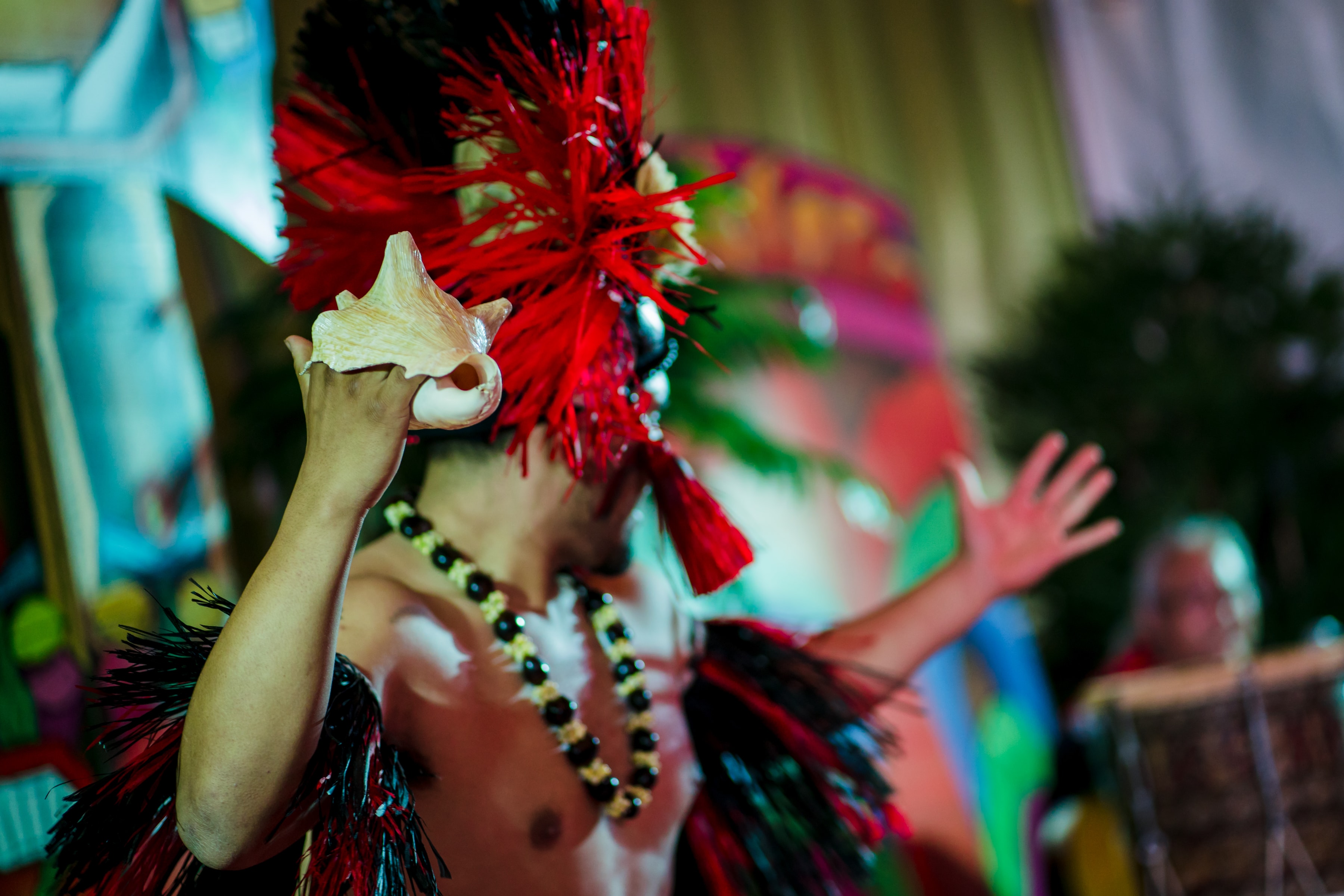 Fire knife dancer performing at a Polynesian luau show event