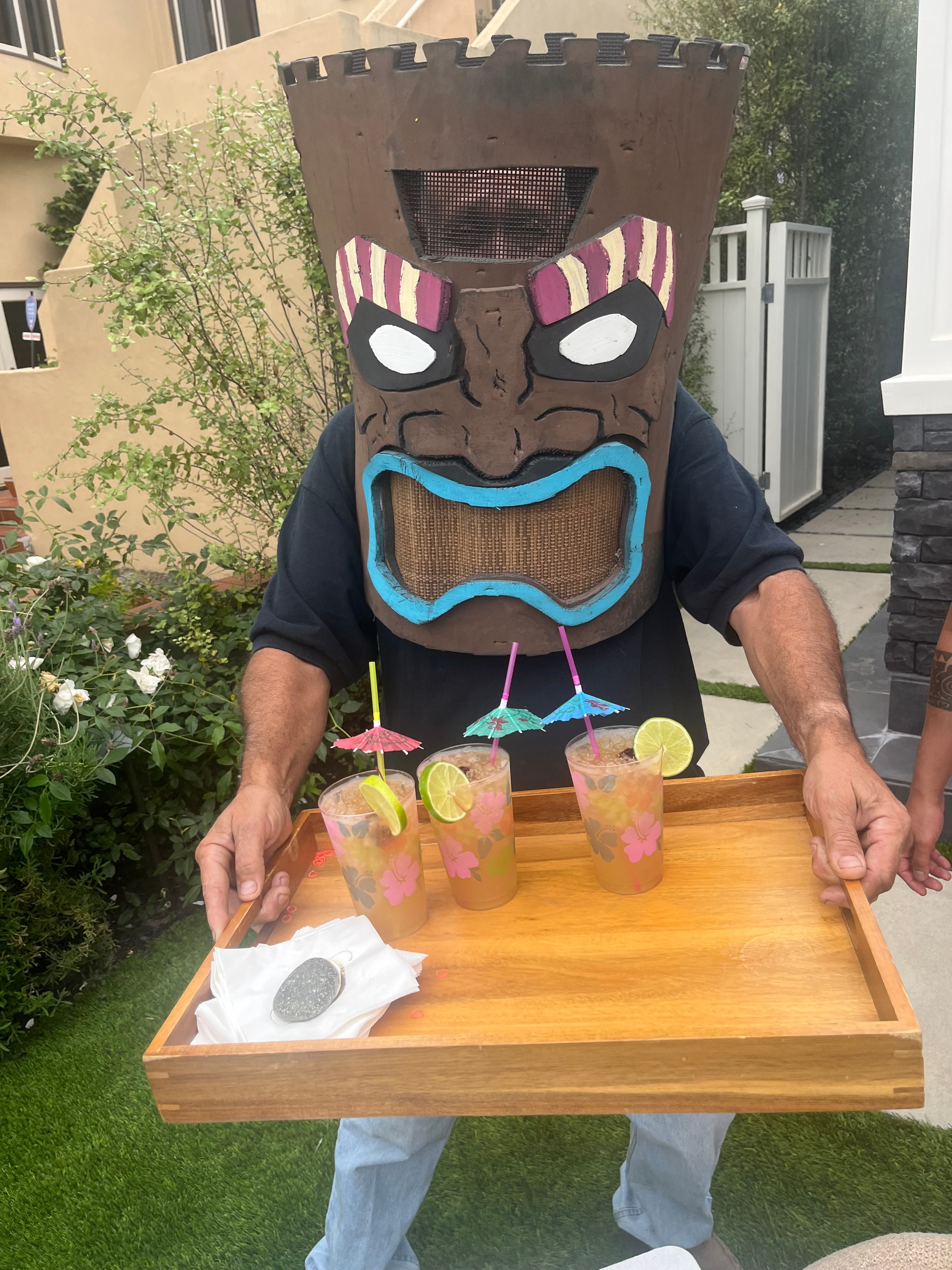 Costumed tiki characters entertaining guests at a tropical corporate event