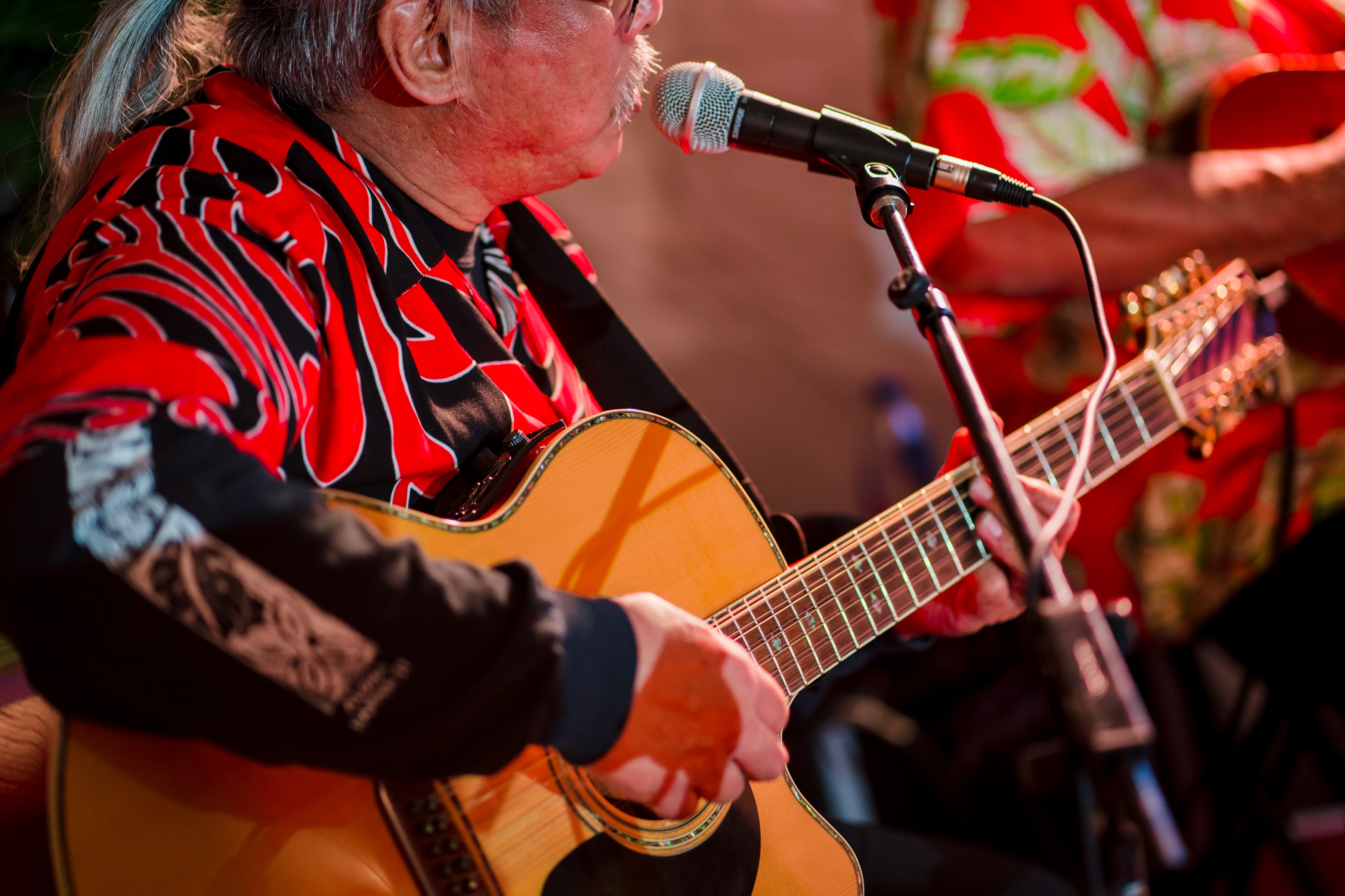 Hawaiian guitarist performing at a luau event